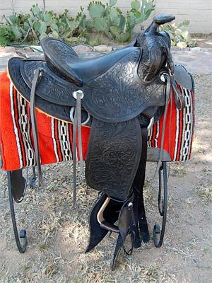Vintage antique fully carved 1950's saddle with tapederos and new fleece in excellent condition.